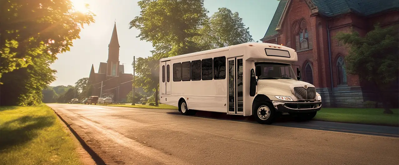 white shuttle bus in front of several churches