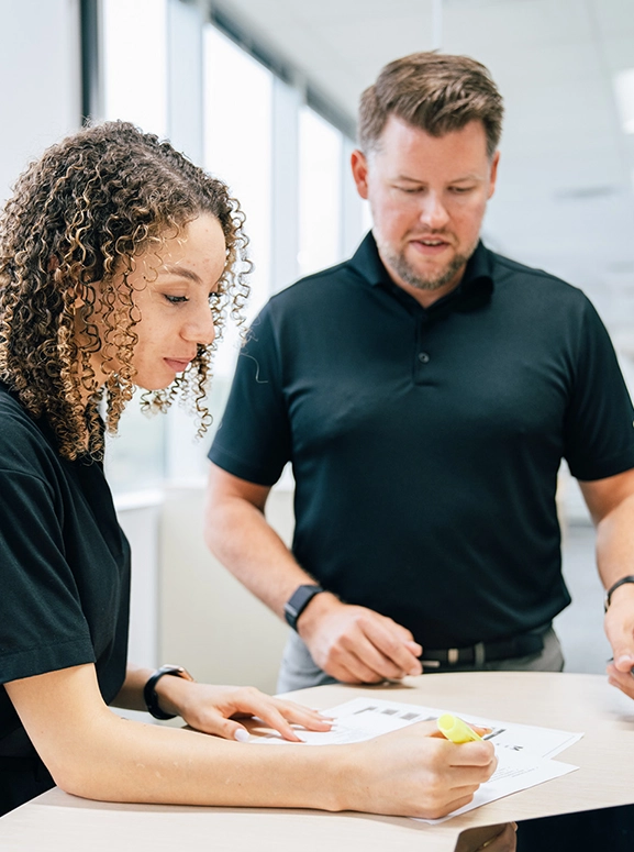 woman and man looking at forms for renting a vehicle in Las Vegas